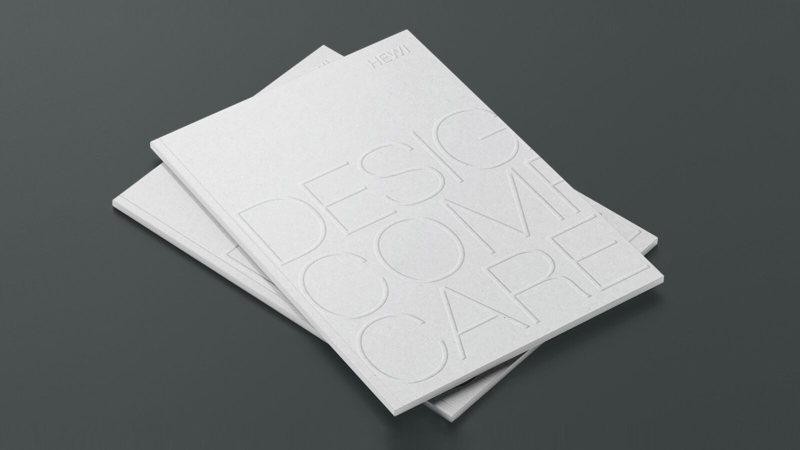 Design Comfort Care Zwei aufeinander gelegte Broschüren mit der Aufschrift Design Comfort Care